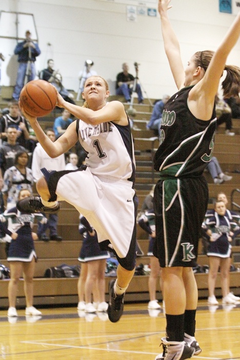 Auburn Riverside guard Mercedes Wetmore elevates for a bucket against Kentwood's Liz Mills this past Thursday at Auburn Riverside High School. Wetmore scored a game-high 22 points in the Ravens 59-56 win.