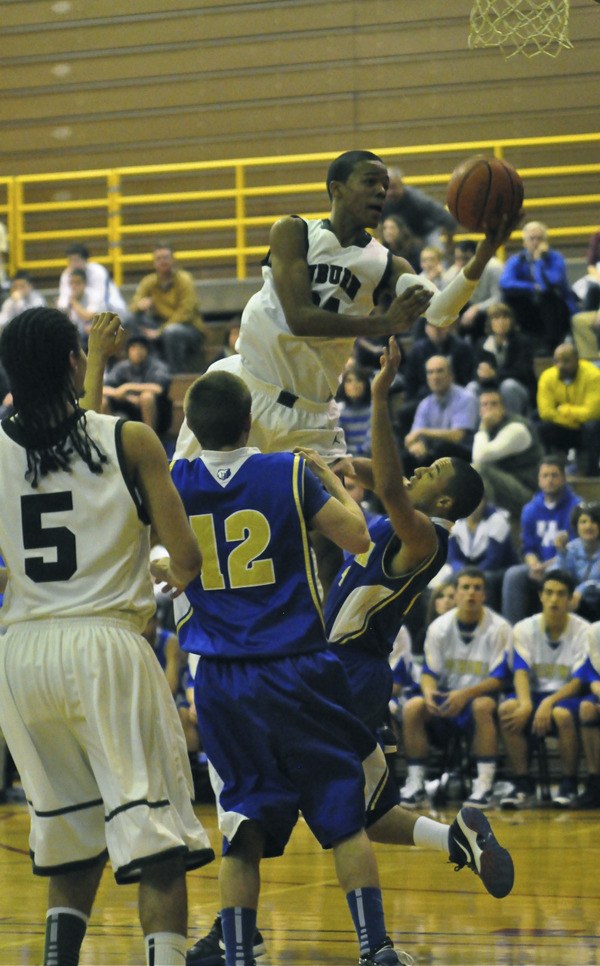 Auburn's Kevin Henderson drives to the bucket against Tahoma.