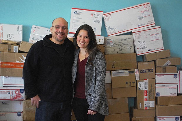 Jason and Cinnamon Miles prepare to send a shipment of purses to Zambia as part of their business’ nonprofit