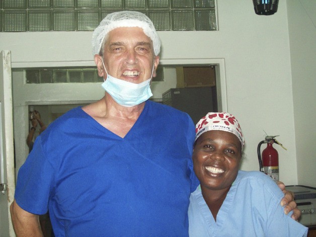 Auburn’s Ben Davis shares a smile with a Haitian hospital worker between surgeries. Davis spent three weeks in the earthquake-damaged country
