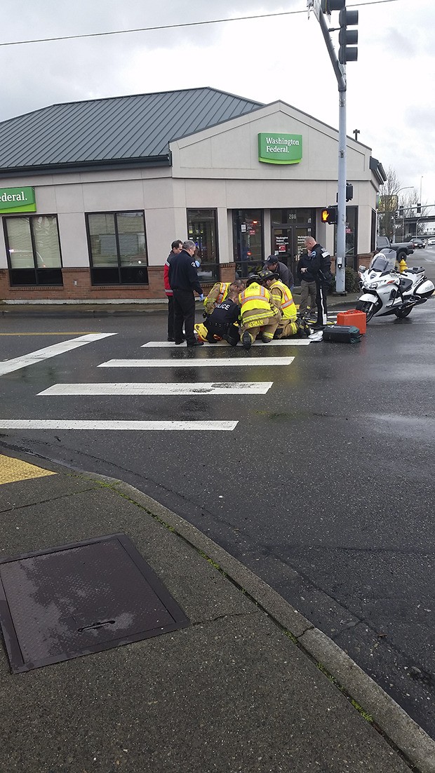 Valley Regional Fire Department personnel surround a bicyclist injured in a mid-afternoon collision Monday with a truck on A Street Southeast