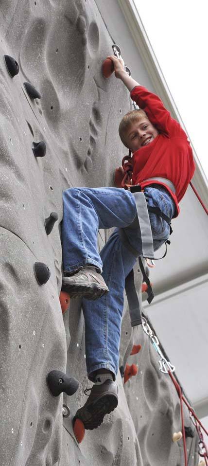 Zach Braid scales the rock wall