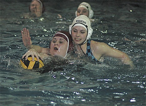 Auburn Riverside water polo player Payton Gray goes for a steal against Enumclaw.