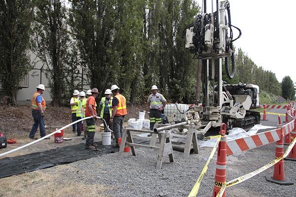 Workers sink a test well in Algona to test for groundwater contaminants next to the Boeing Auburn Plant.