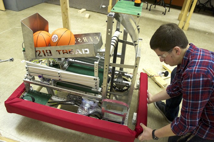 A member of the Auburn TREAD 3219 robotics team works on the teams entry into this year's FIRST Robotics Northwest regional competition.