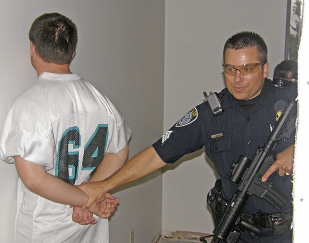 Algona Police Sgt. Lee Gaskill ascertains a mock suspect during a building search drill in September 2008
