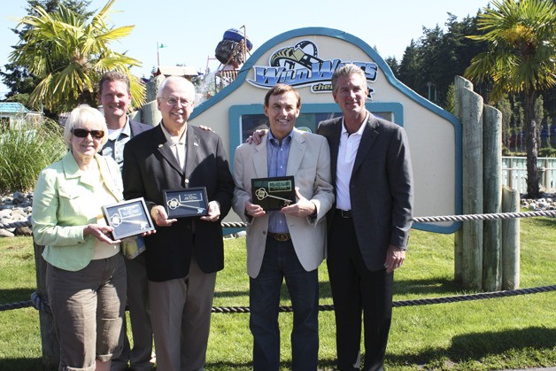Local civic leaders officially opened the Wild Waves Amusement Park for the month of July. From left