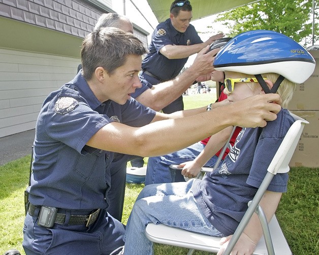 Valley Regional Fire Authority firefighter Meghan Loudon fits a helmate on Jacob Melberg