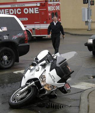 An Auburn police motorcycle officer was seriously injured after colliding with a motorist at the intersection of West Main and Division streets Tuesday.