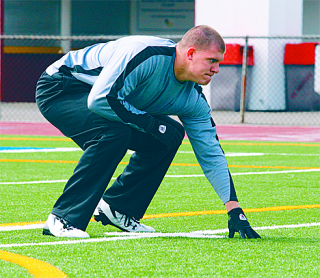 Jefferson graduate Jared Bronson works out for Jacksonville Jaguar Assistant Coach Mike Tice at Federal Way's Memorial Stadium.