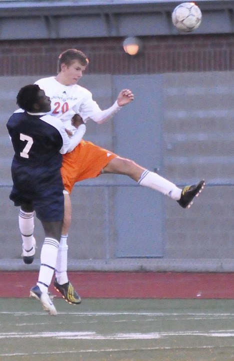 Defender Sergey Rubakha takes to the air to win the ball against Lakes.