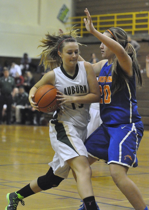 Auburn’s Maysen Tinney drives on Auburn Mountainview’s Savannah Klemetson. The Lions beat the Trojans 65-27.