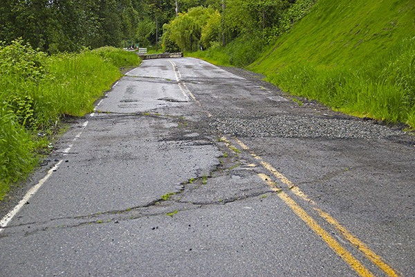 Sinkholes and cracks mar the pavement on the closed section of West Valley Highway.