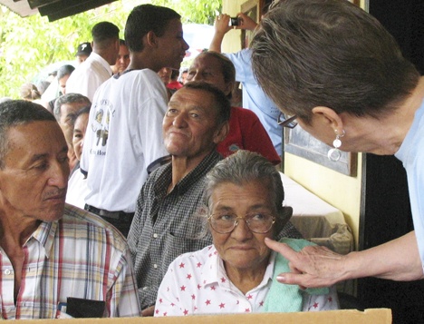 A woman has her glasses inspected during Sen. Pam Roach's recent visit to Honduras.