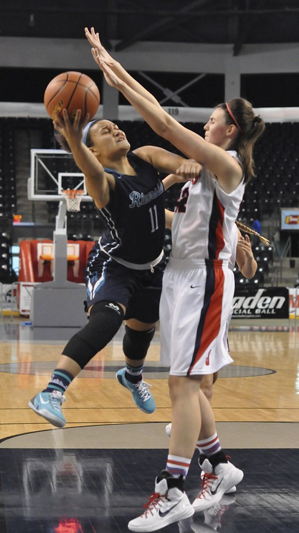 Auburn Riverside's Olivia Denton goes for the lay up against Juanita's Shelley Waltar at the King Showcase at the ShoWare Center in Kent.