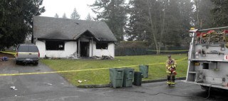 Firefighters work the scene of a house fire on the Muckleshoot Reservation on Thursday morning. Crews from the Black Diamond Fire Department