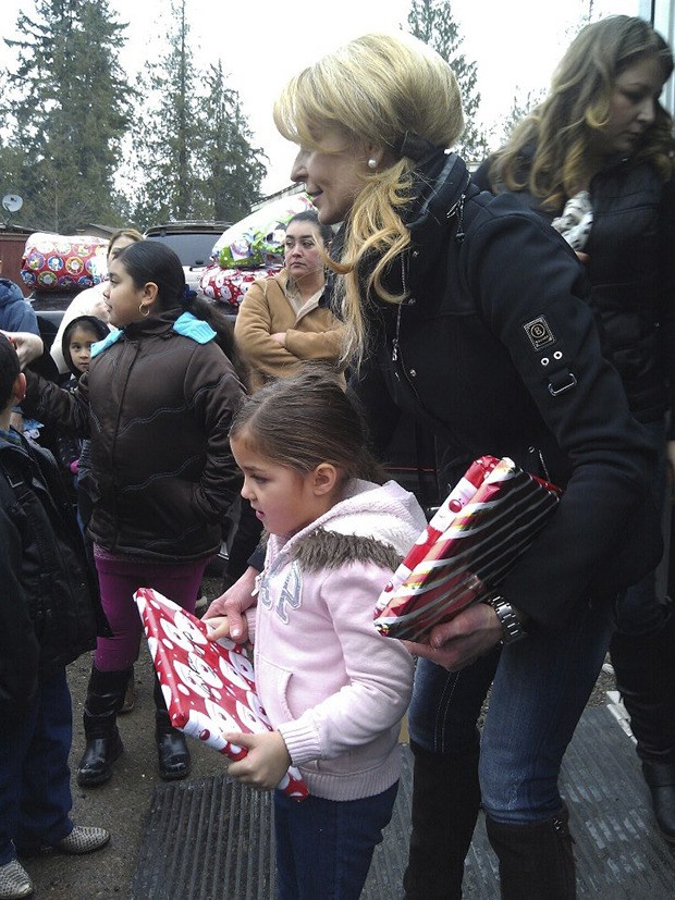 Reaching out: Diane Rupert and her supporters with the Giving Tree program recently distributed gifts to families and children at an adopted mobile home park near Auburn.