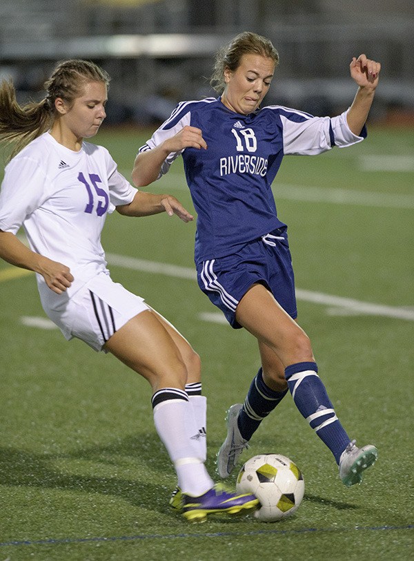 Auburn Riverside's Calli Millang and Sumner's Emma Bakke vie for control of the ball during Tuesday's match.
