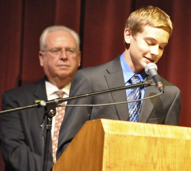 Gresch Jenson reads an essay he wrote as Mayor Pete Lewis looks on during the recent Reaching Out Fair at the Auburn Performing Arts Center. The resource information fair – co-hosted by the Auburn School District