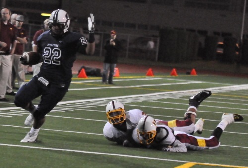 Raven Jordan Moore leaves a pair of Raider defenders in the dust as he scores on a 15-yard touchdown run.