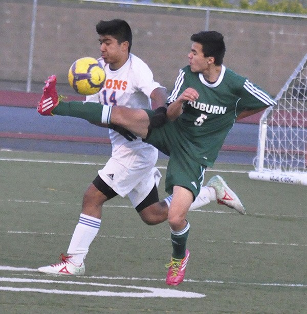 Auburn's Hector Garcia tries to keep the rock away from Auburn Mountainview's Erik DeAnda.