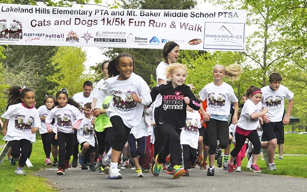 Children dart at the start of the Cats and Dogs 1K Fun Run at Roegner Park last Saturday.