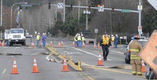 Puget Sound Energy workers and Auburn police work the scene of a natural gas leak at 41st and A Street Southeast on Wednesday.