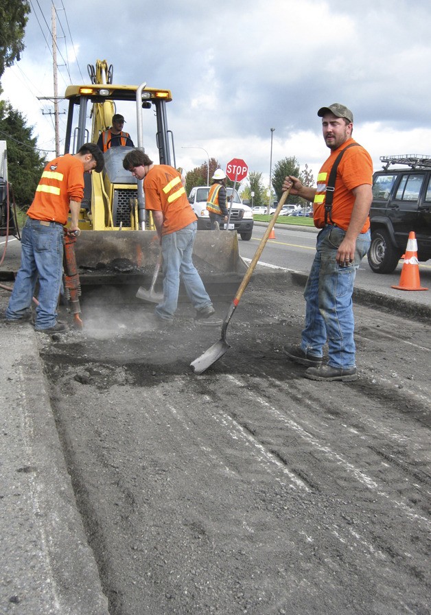A City crew grinds out the surface pavement on West Valley Highway North
