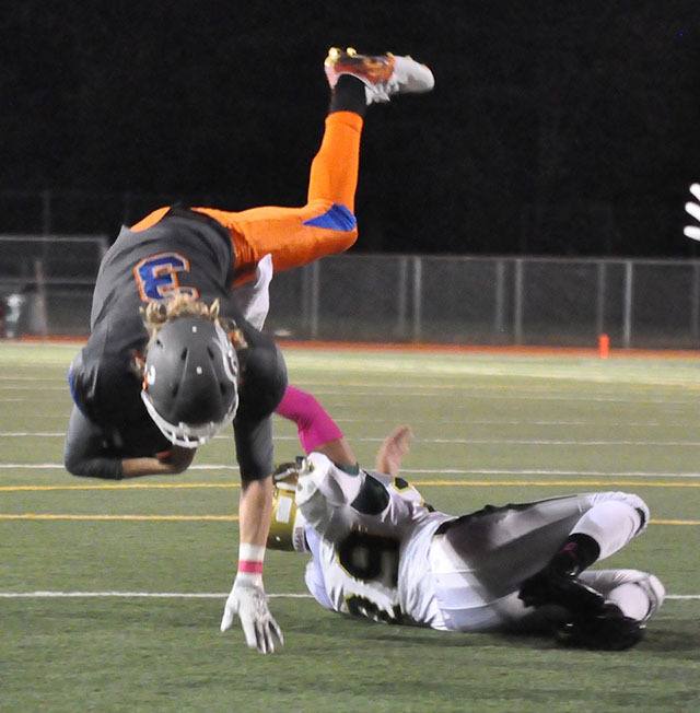 Auburn's Justice Tuia upends Auburn Mountainview quarterback Talan Alfrey during NPSL Olympic Division play Friday night. Alfrey and the Lions rolled to a 42-21 win.