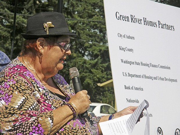 Sandy Goodenhow describes to officials how the King County Housing Authority's renovated Green River Homes on M Street Southeast are a blessing to live in.