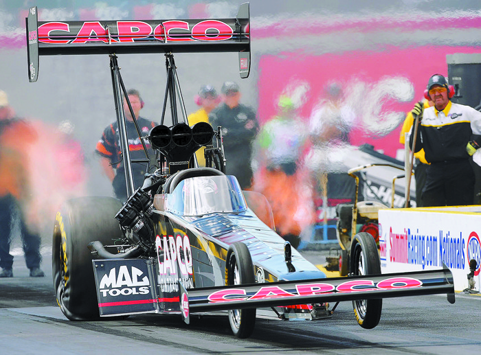Steve Torrence and the Capco Top Fuel dragster launches off the starting line.