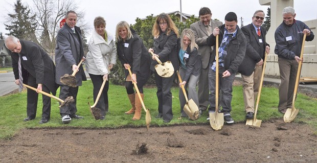 School district officials join the principal contractor and architect to celebrate the groundbreaking for the Auburn High School reconstruction and modernization project. From left