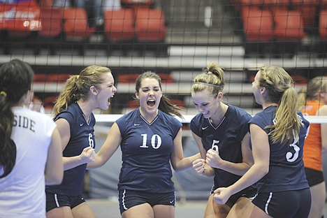 The Auburn Riverside volleyball team celebrates at the Washington State 4A Volleyball Championships.