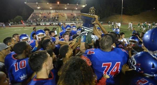 The Kent-Meridian Royals hold aloft the Taylor Trophy after a 42-39 overtime win against Auburn.