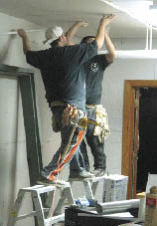 Volunteers fix the wing of the White River Presbyterian Church  occupied by ACAP.