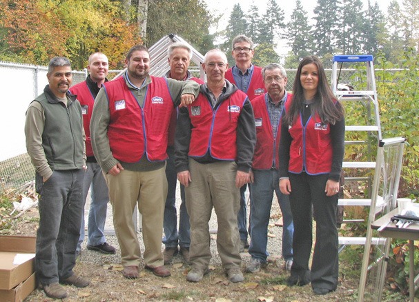 A team from the Auburn Lowe’s store helped deliver and install a 6-foot-by-16-foot greenhouse for Camelot Elementary School’s community garden.