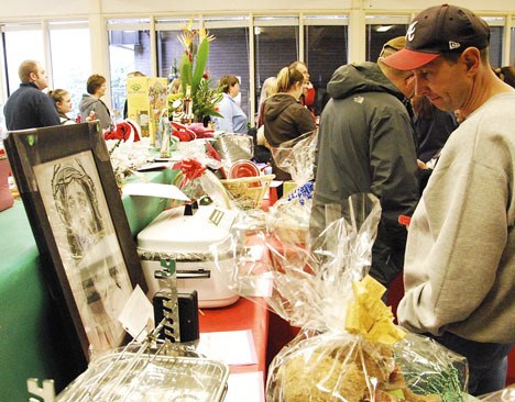 Tom Mathis Looks at some of the items for sale at the 45th Holy Family Church Bazaar held last weekend at the parish center. For the first time in its long history