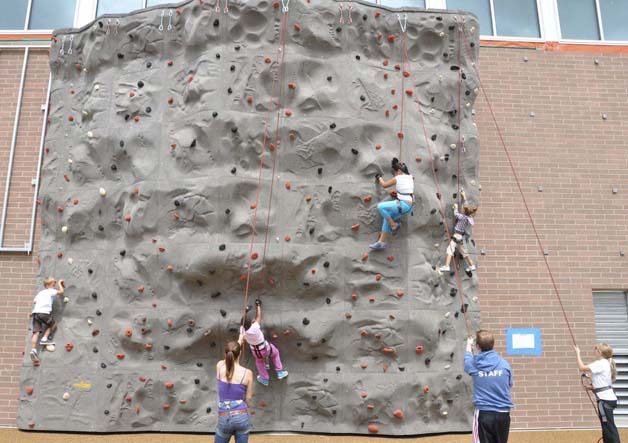 Young explorers attempt to scale the climbing wall