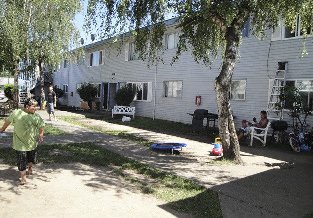Children play in the Auburn Pines Apartments courtyard last summer. The complex was  condemned last June. A new group has since purchased the dilapidated apartments and plans a full-scale renovation.