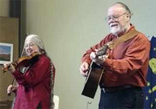Vivian and Phil Williams entertain music lovers at the Muckleshoot Library last Saturday. The internationally-renowned folk duo performed a program featuring dance songs from the Alaskan Gold Rush era of the late 1800s and early 1900s. The family program celebrated the music played in saloons and dance halls during that time. The show featured traditional songs played on fiddle