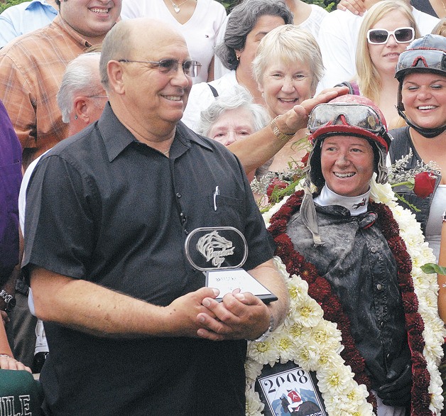Howard Belvoir and jockey Jennifer Whitaker enjoy their moment in the winner’s circle after the 2008 Longacres Mile