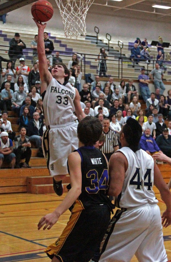 Auburn Adventist senior Gabe Chaikin scores as teammate Sheldon Sui (44) looks on.