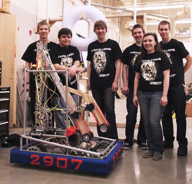 Select members of the Auburn Mountainview Robotics Club show off their mechanical creation