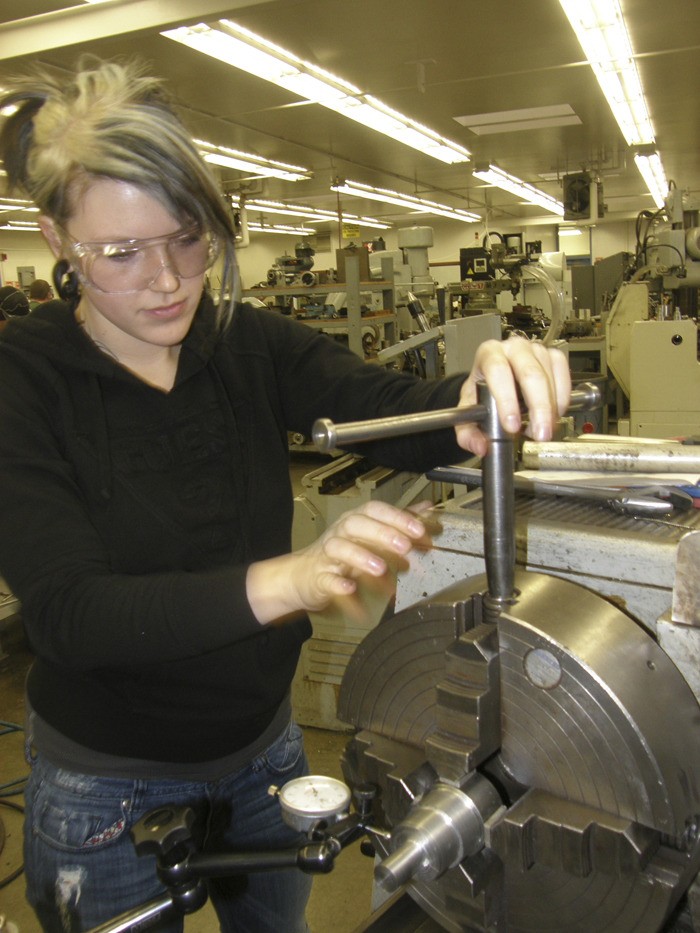 Auburn’s Rachell Bechtle adjusts a lathe during a precision machining class  at Green River Community College.