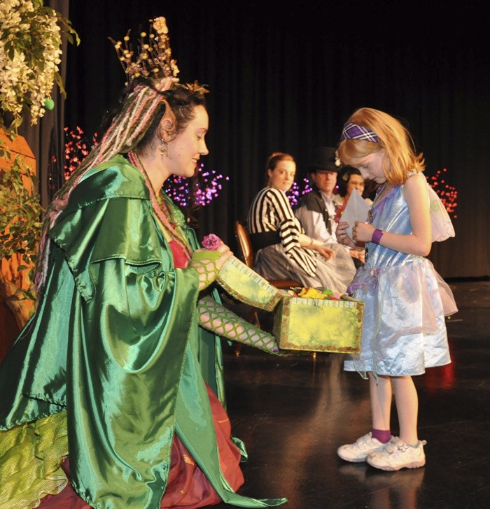 Princess Lolly offers up a prize from her treasure chest to costume contest winner Ivy Francis