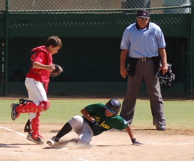 Isaiah Hatch scores for the Auburn Little League All-Stars against the Alaskan All-Stars. Auburn lambasted the team from Alaska 16-1.