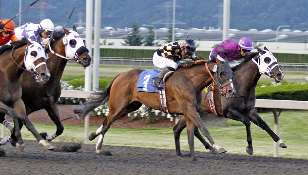 Rezar (No. 3) and jockey Javier Matias prevail in a close finish in the feature race for 3-year-olds and up at Emerald Downs. The 4-year-old Kentucky-bred gelding by Songandaprayer ran six furliongs in 1:08.57.