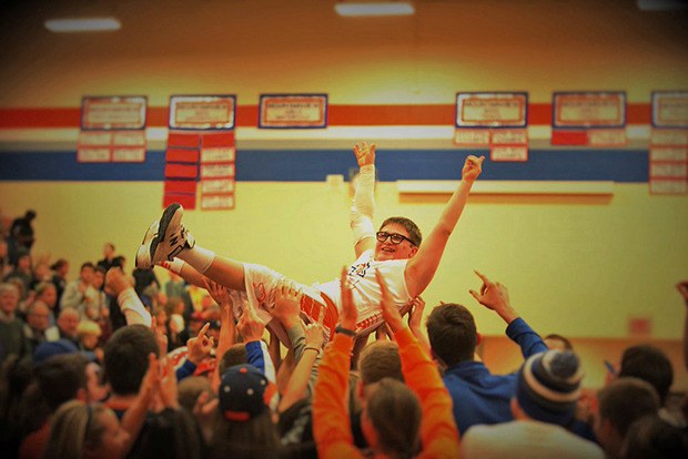 Fans hoist and carry Cole Buchanan off the floor after the Auburn Mountainview basketball team manager got a long-awaited chance to play in a game Friday night. Buchanan entered the game in the final minute and shot a pair of free throws in the Lions' win against Enumclaw.