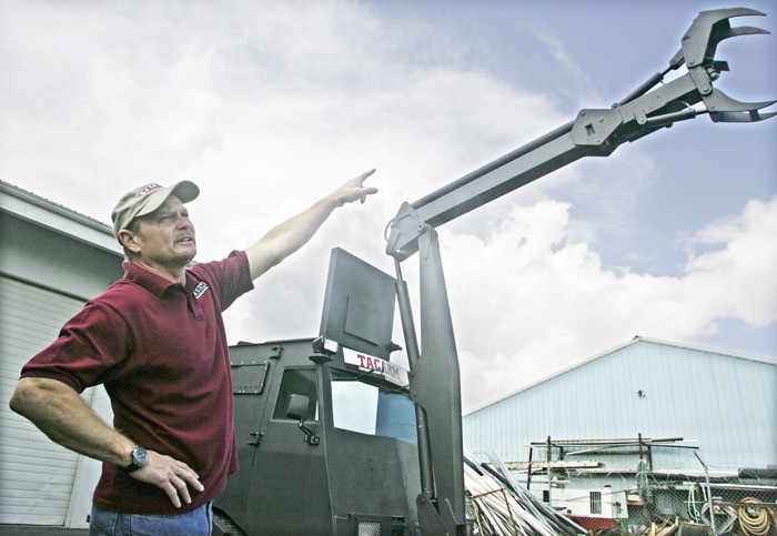 Don Wilde of TACARM demonstrates the boom of his company's armored vehicle