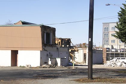 Crews begin to demolish a building on the Gambini block off South Division between First and Second streets southeast. Plans are to build a four-story retirement community in its place.